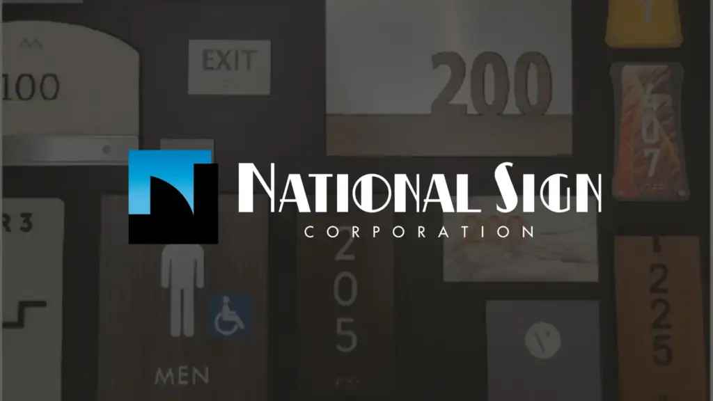 Logo of National Sign Corporation over a blurred background featuring various signage, including room numbers, exit sign, and men’s restroom symbol with accessibility icon.
