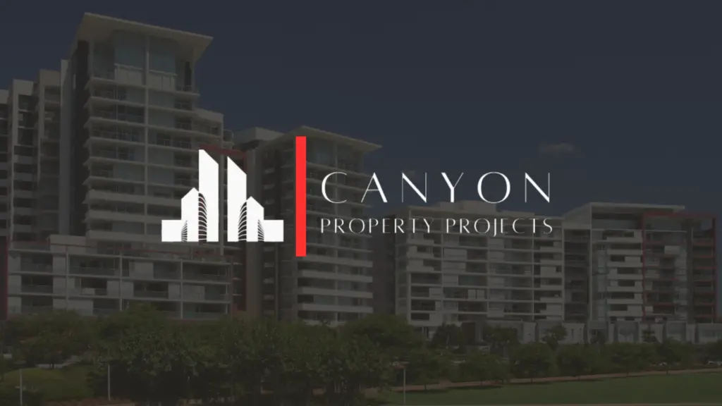 Logo for Canyon Property Projects with stylized buildings and text overlay, positioned in front of a modern multi-story apartment complex.